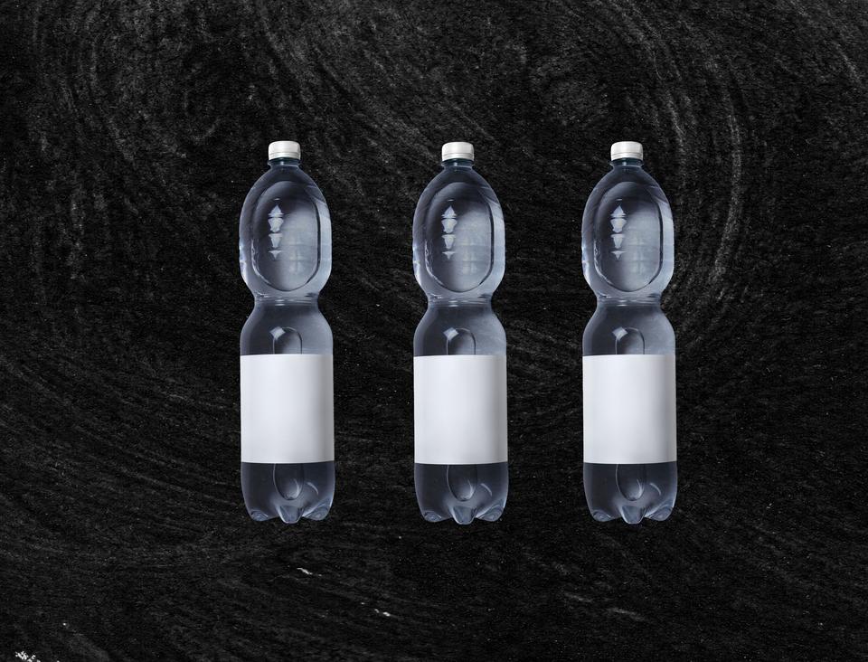 Three sealed water bottles with blank labels